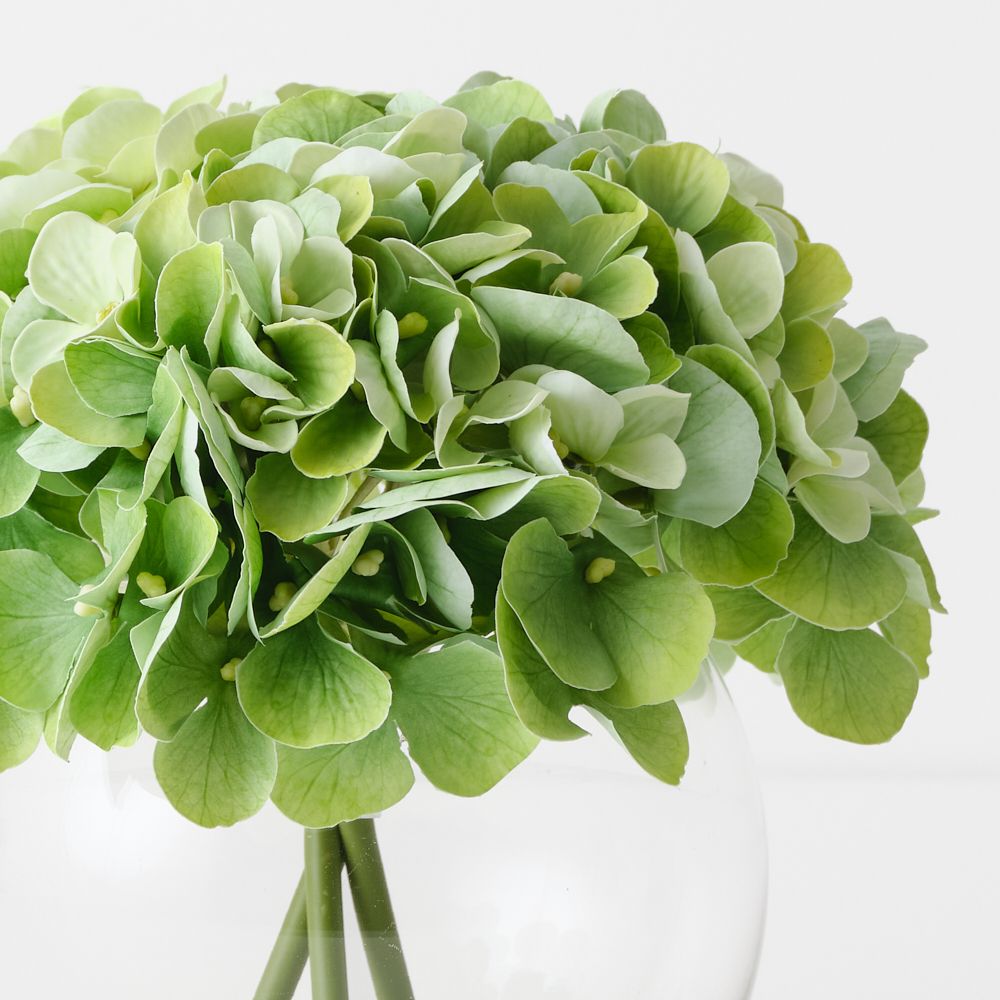 Artificial light green hydrangeas in small round glass vase – view 2