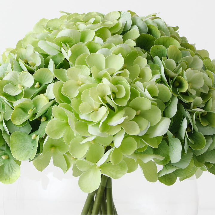 Artificial light green hydrangeas in large round glass vase – view 2