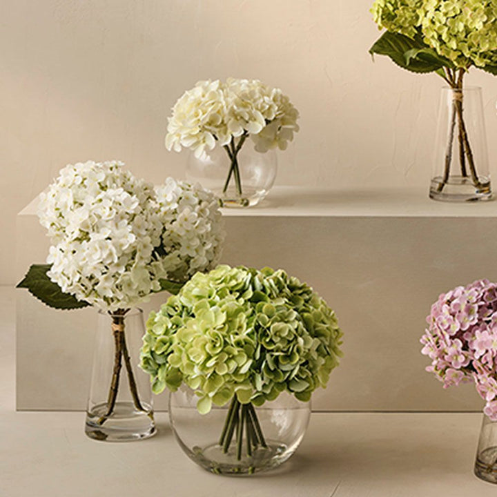 Artificial light green hydrangeas in large round glass vase – view 3